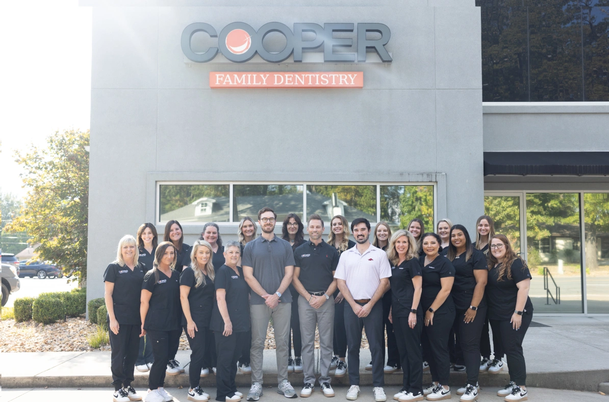 Cooper Family Dentistry team standing together outside their dental office building.